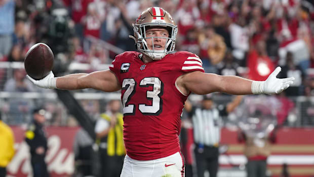 Christian McCaffrey holds his arms up after a touchdown.
