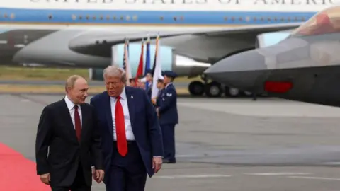 EPA Vladimir Putin and Donald Trump walking together on the runway in Alaska