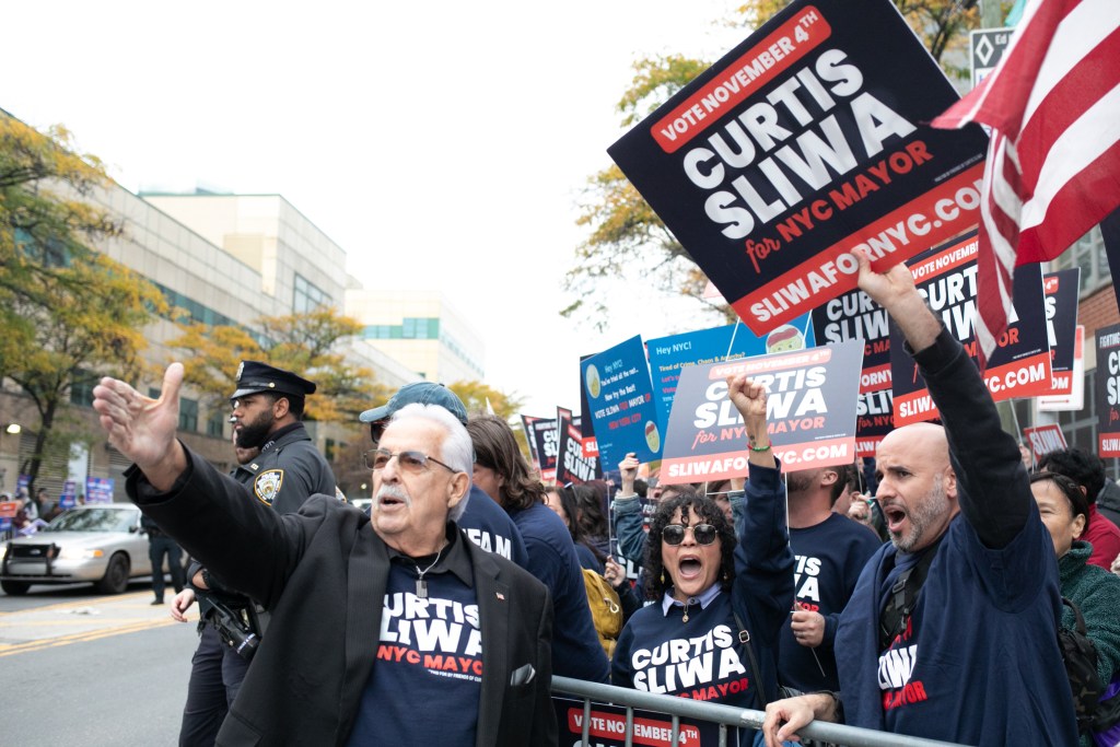 Supporters of Republican mayoral nominee Curtis Sliwa await his arrival at LaGuardia College in Queens for the final debate,