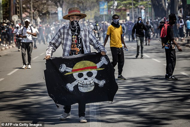 A protestor holds the Japanese anime symbol at a rally that ended with the resignation of Madagascar's president