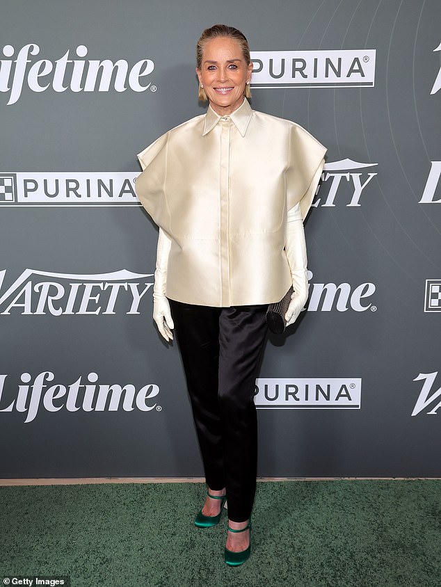 Sharon Stone turned heads in a bizarre satin blouse styled with arm-length gloves and green Mary Jane heels