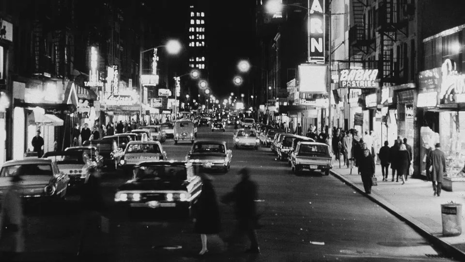 View of cars and club marquees on Eighth Street at night, looking east from Sixth Avenue in New York's Greenwich Village on November 18, 1965. - Larry C. Morris/New York Times Co./Getty Images