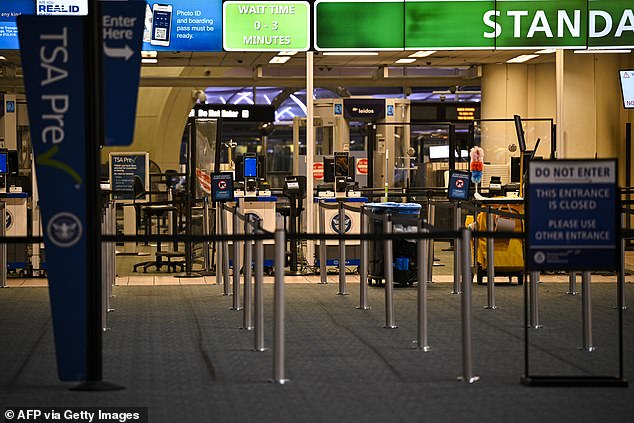 The TSA counter stands empty at Orlando International Airport in Orlando, Florida on October 30, 2025. Flights at Orlando International Airport faced major delays on October 30, after the Federal Aviation Administration (FAA) said the airport had no certified air-traffic controllers in its tower, forcing arrivals to be halted or severely delayed amid the ongoing US government shutdown. Air traffic controllers -- seen as "essential" public servants -- are kept at work during government shutdowns, but higher numbers are calling in sick rather than toiling without pay, leading to shortages. (Photo by Miguel J. Rodriguez Carrillo / AFP) (Photo by MIGUEL J. RODRIGUEZ CARRILLO/AFP via Getty Images)