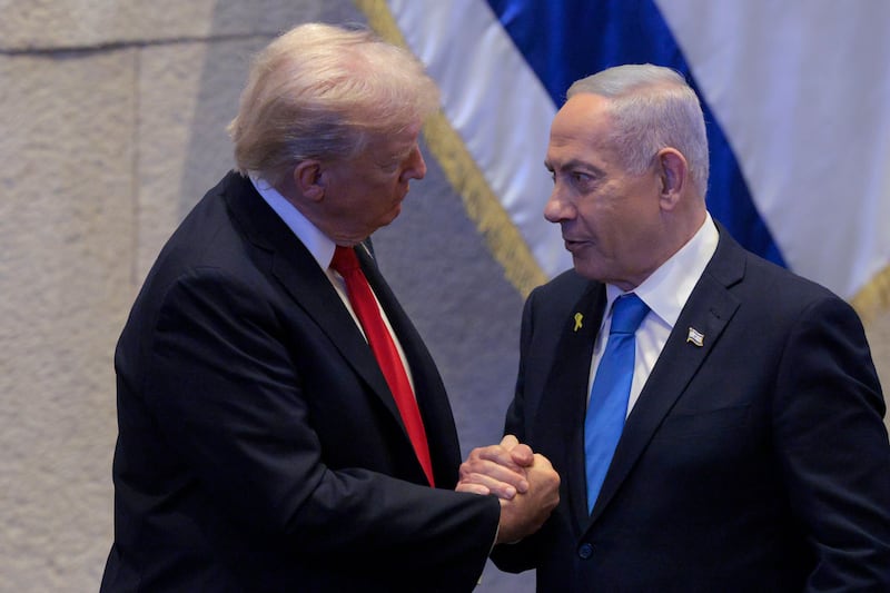 President Donald Trump Israeli and Prime Minister Benjamin Netanyahu interact after Netanyahu addressed the Knesset on October 13, 2025 in Jerusalem.