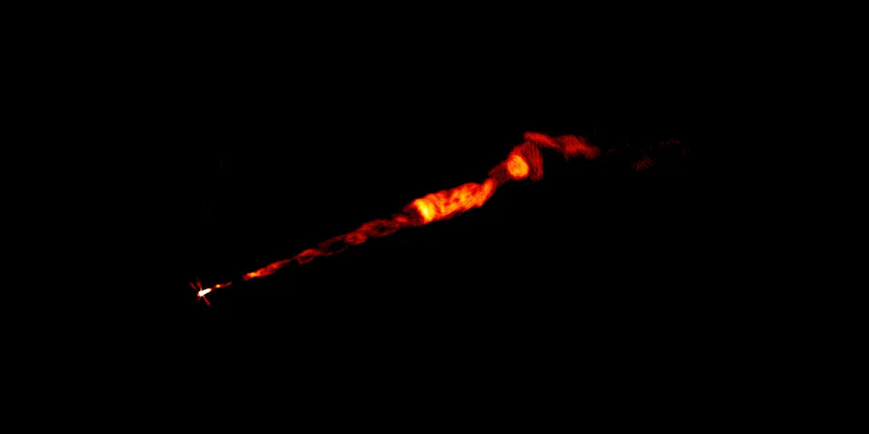 Radio wave image of an orange jet shooting out of a black hole.