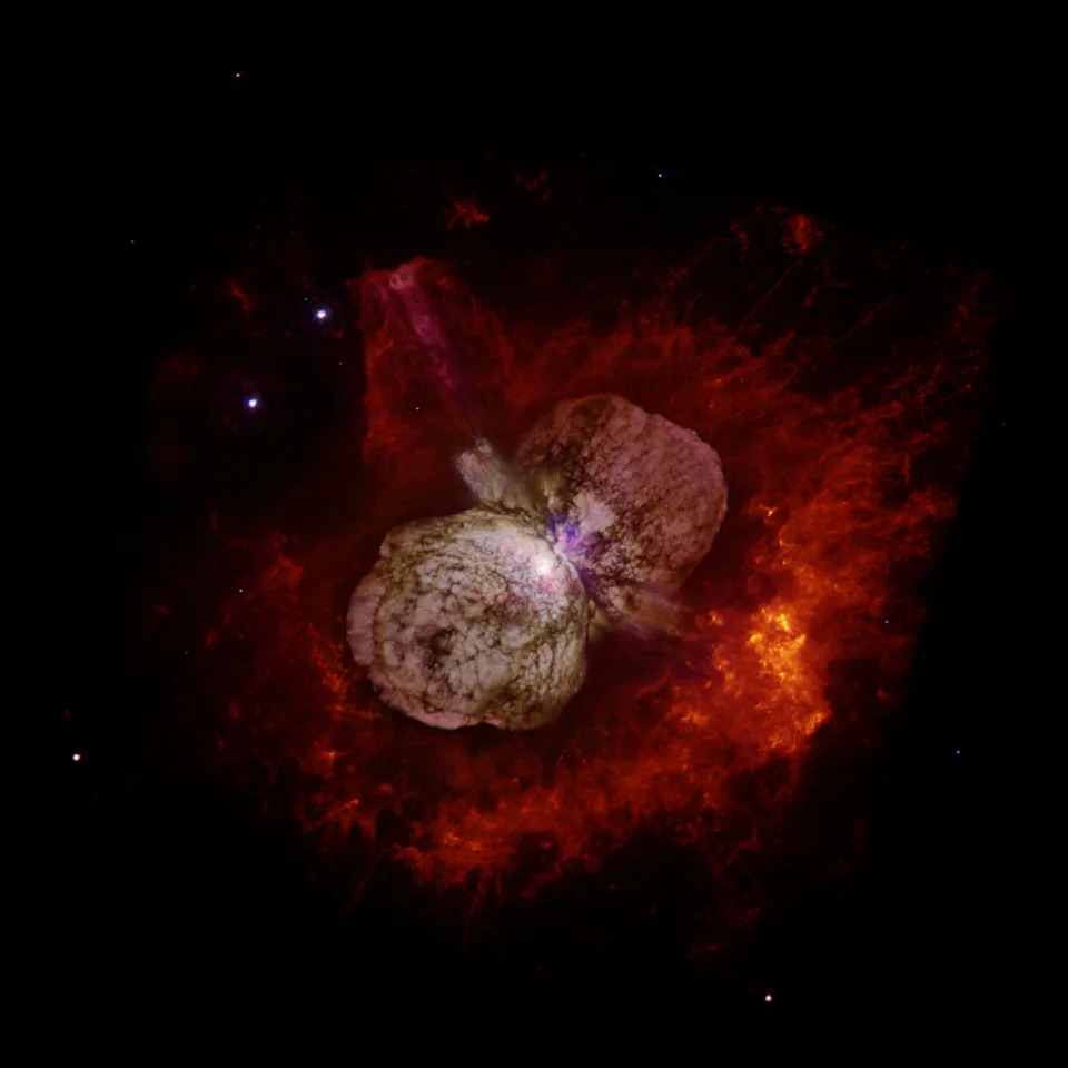 A huge red cloud of gas and dust in space.