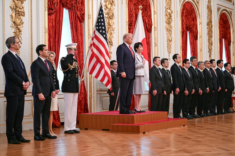 Japan's Prime Minister Sanae Takaichi (centre R) and US President Donald Trump review an honour guard of the Japan Self-Defense Force at the Akasaka State Guest House in Tokyo on October 28