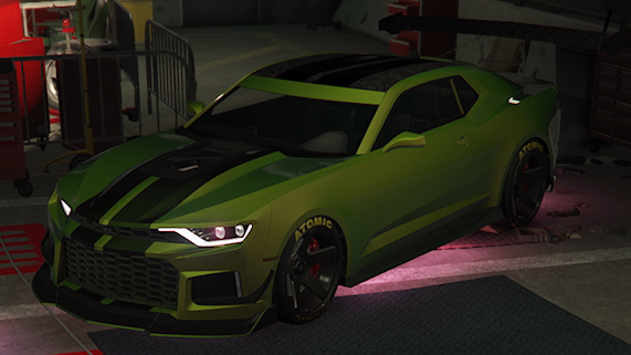 A low-angle screenshot of a lime green Declasse Vigero ZX muscle car, designated as the Premium Test Ride Vehicle in Grand Theft Auto Online. The car has black racing stripes over the hood and roof, a custom front splitter, and black custom wheels with Atomic brand tires. It is parked indoors in what appears to be a garage or workshop setting, with tools and equipment slightly visible in the background. Pink ambient lighting highlights the area beneath the car.
