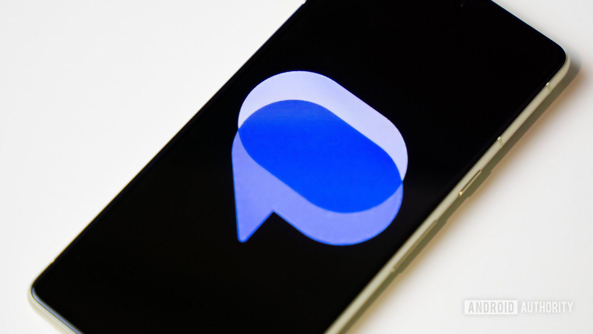 Google Messages logo on smartphone laying on table (3) Google Messages logo on smartphone laying on table (3)