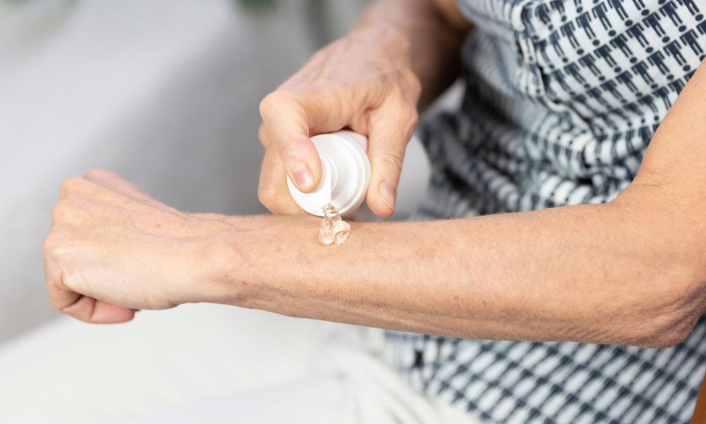 A person applying HRT gel.