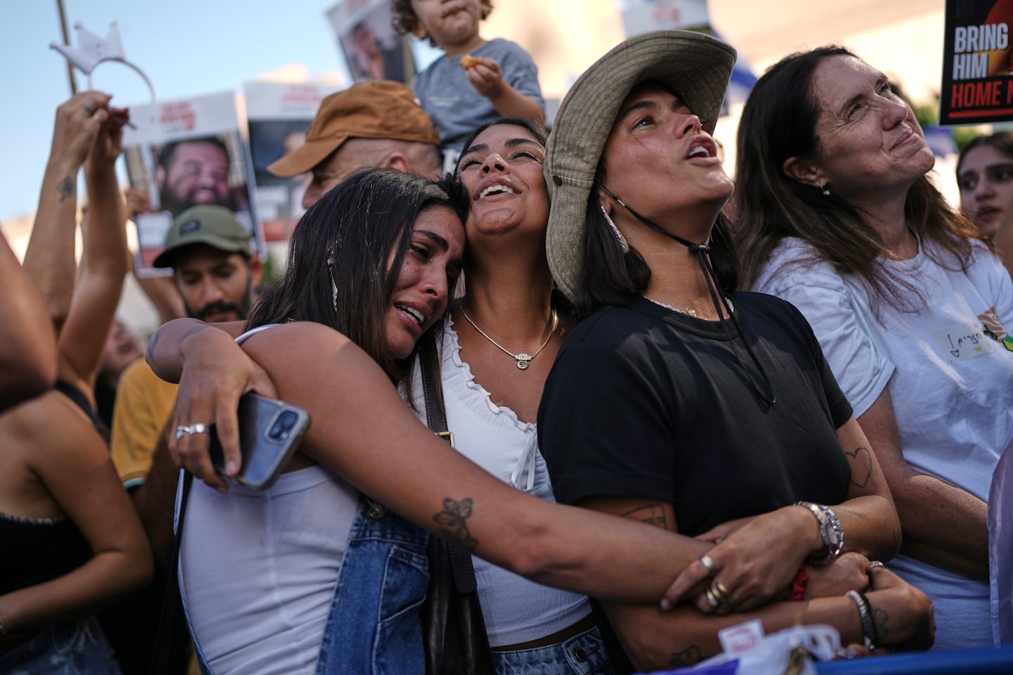 People react as they gather to watch a live broadcast of Israeli hostages released from Gaza at a plaza known as hostages square in Tel Aviv, Israel.