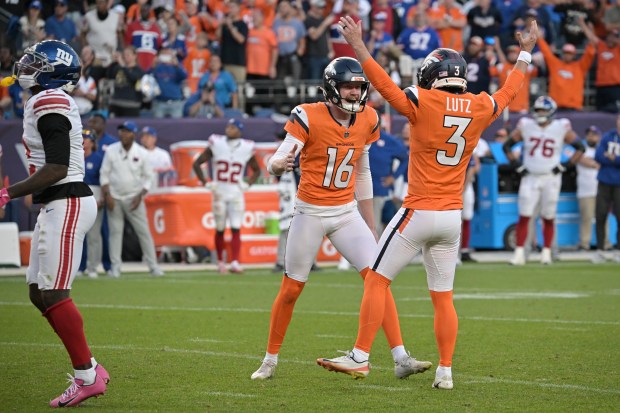 Denver Broncos Jeremy Crawshaw (16) and Wil Lutz (3) celebrate the game-winning field goal against the New York Giants at Empower Field at Mile High in Denver on Sunday, Oct. 19, 2025. (Photo by Hyoung Chang/The Denver Post)