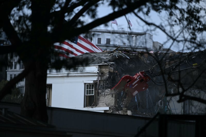 Heavy machinery tears down a section of the East Wing of the White House as construction begins on President Donald Trump's planned ballroom, in Washington, DC, on October 22, 2025. US President Donald Trump held a glitzy dinner October 15, 2025 to thank billionaires and top companies for donating to the new $250 million ballroom he is building at the White House. The guests included representatives from tech firms like Amazon, Apple, Meta, Google, Microsoft and Palantir and defense giant Lockheed Martin, according to US media citing a White House guest list. (Photo by Brendan SMIALOWSKI / AFP) (Photo by BRENDAN SMIALOWSKI/AFP via Getty Images)