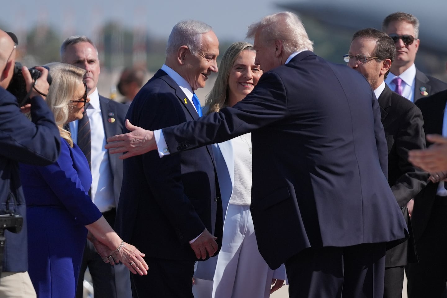 President Trump gestures to Sara Netanyahu as he greets Israel's Prime Minister Benjamin Netanyahu, Israel's President Isaac Herzog, and his wife Michal during an arrival ceremony at Ben Gurion International Airport, near Tel Aviv.