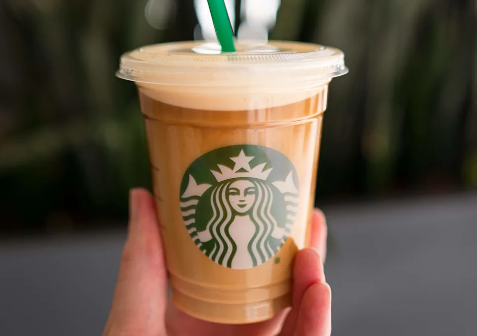 Hand holding a Starbucks Nitro Cold Brew coffee, in the Financial District neighborhood of San Francisco, California, September 26, 2016. Nitro Cold Brew is a coffee drink introduced in select markets, which is processed using nitrogen to create a creamy froth on the top of drink. (Photo via Smith Collection/Gado/Getty Images).