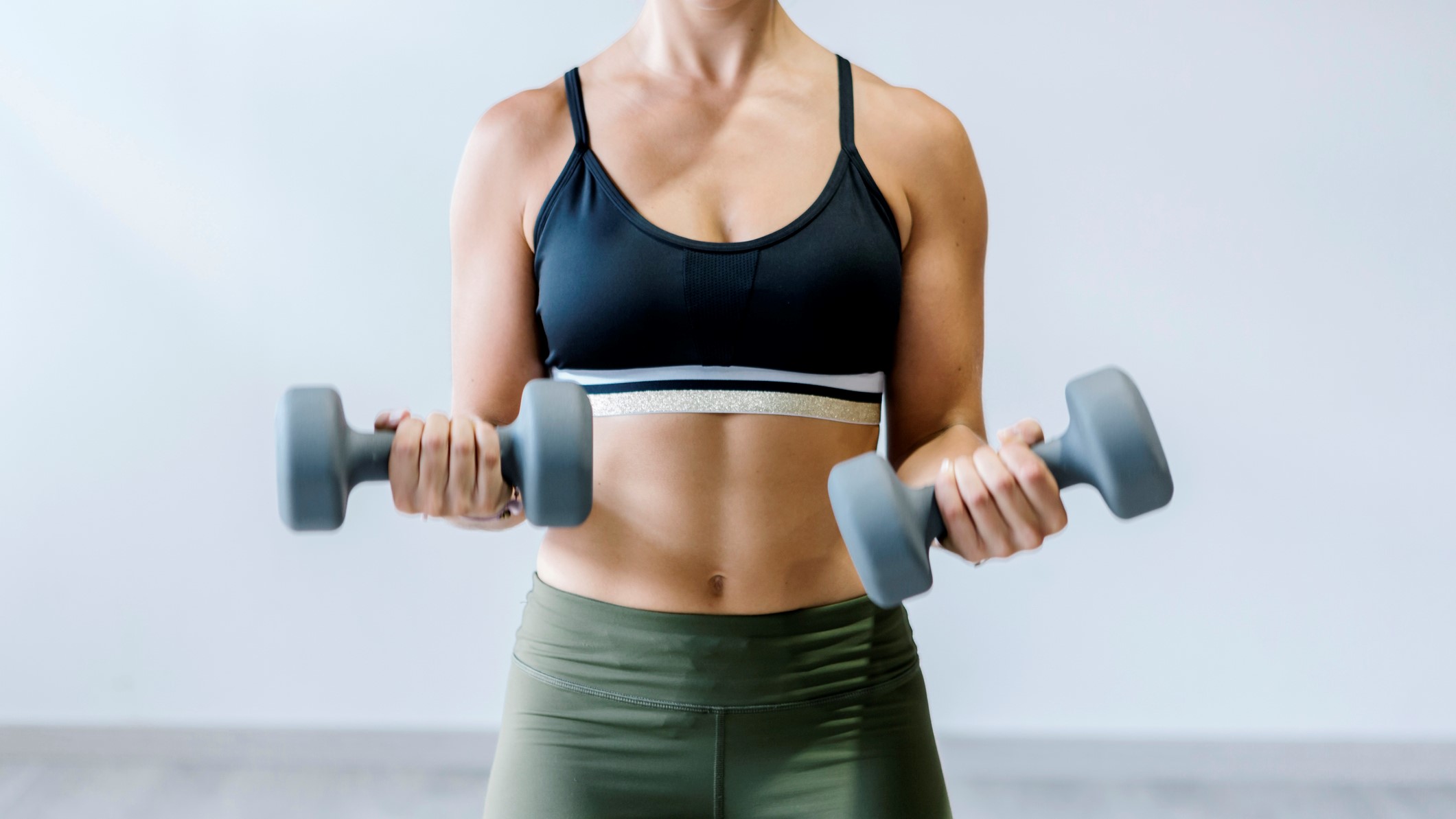 this woman holding a dumbbell workout