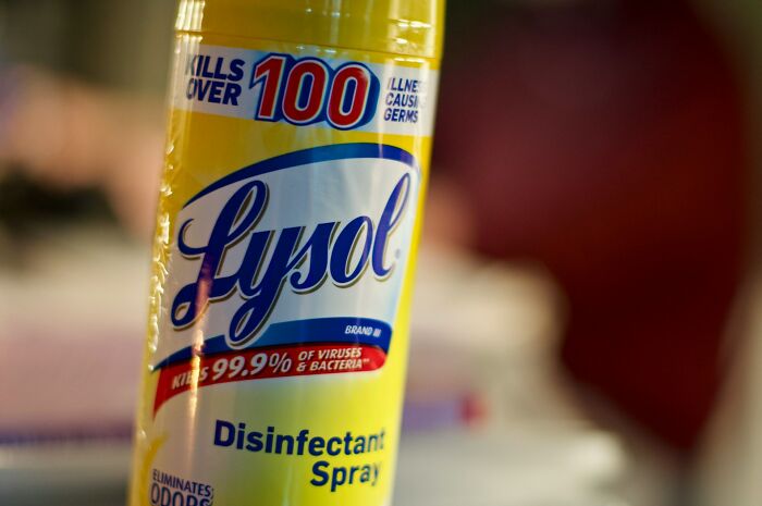 Close-up of Lysol disinfectant spray bottle highlighting germs and bacteria kill claims related to strange health hacks.