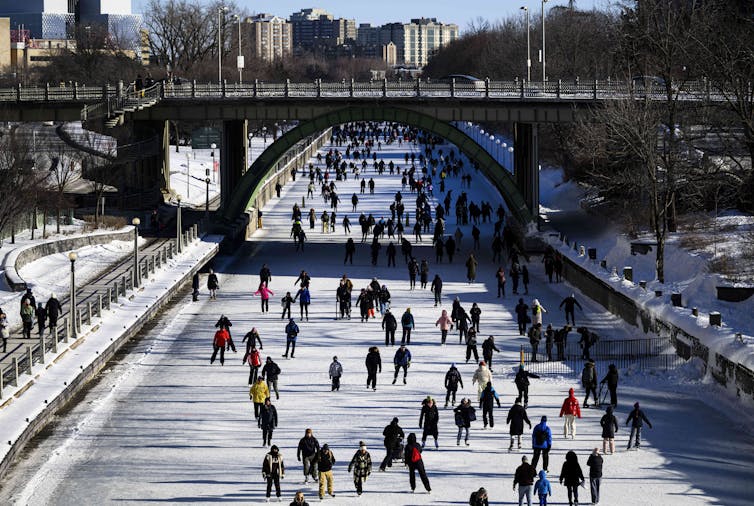 People skate on a frozen canal