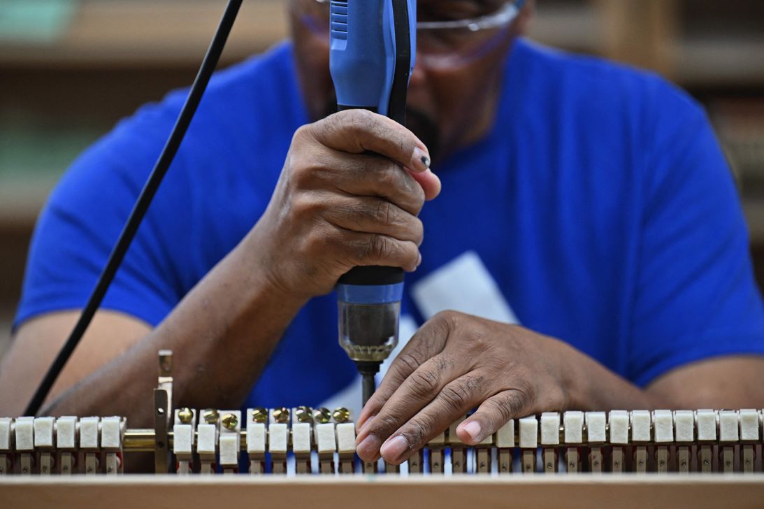 A worker builds a piano at Steinway & Sons Factory in Queens, New York, on October 10, 2023.