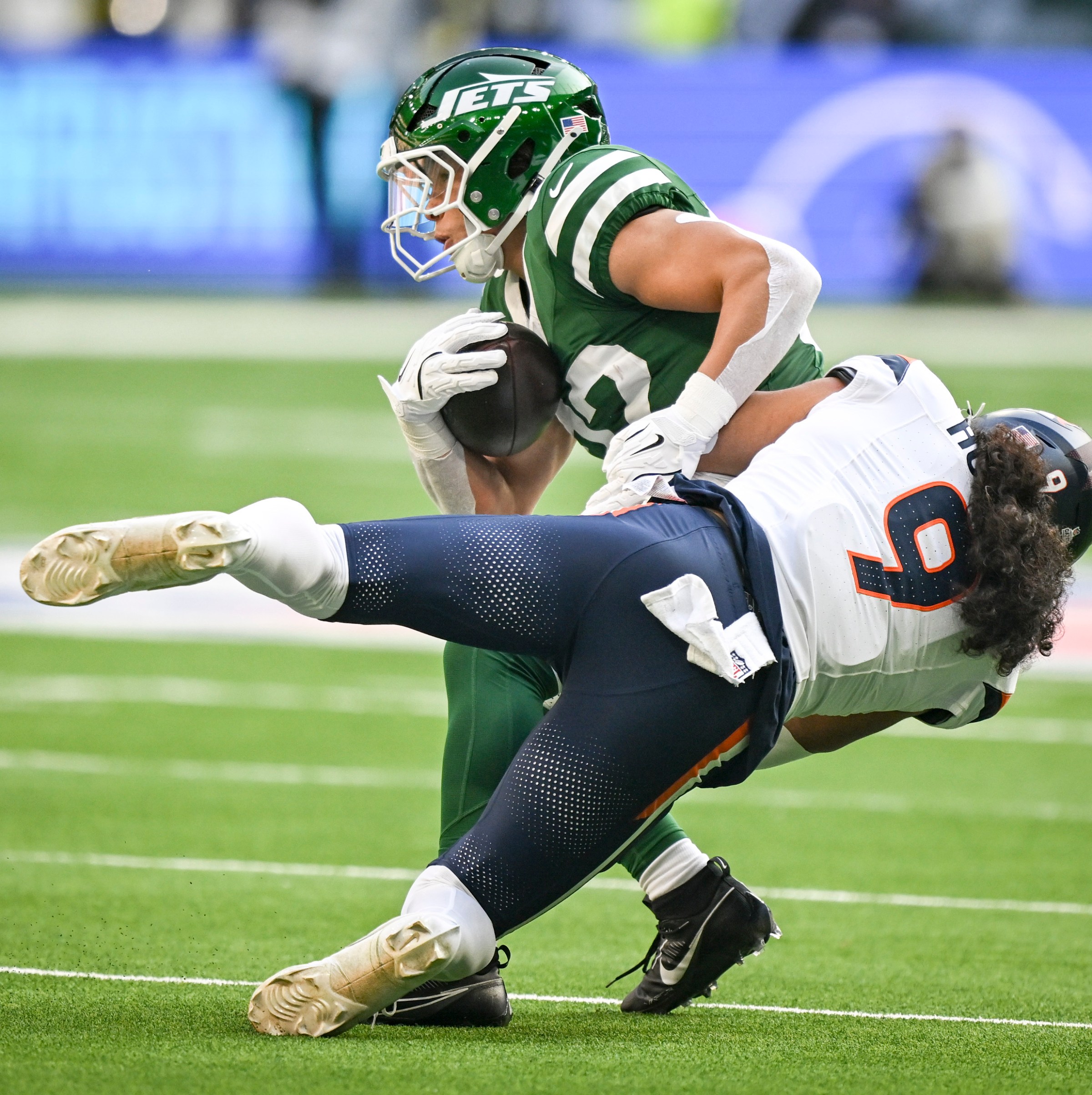 LONDON , ENGLAND - OCTOBER 12: Talanoa Hufanga (9) of the Denver Broncos tackles Isaiah Davis (32) of the New York Jets during the first quarter at Tottenham Hotspur Stadium in London on Sunday, October 12, 2025. (Photo by AAron Ontiveroz/The Denver Post)
