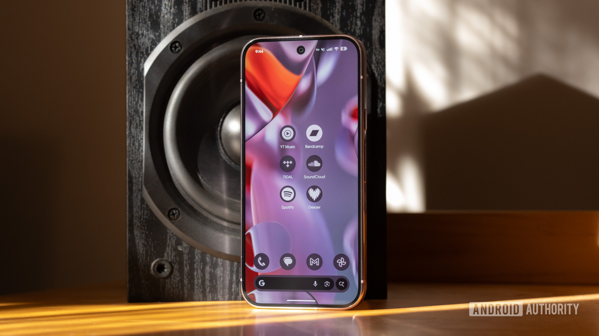 google pixel 9 pro music streaming apps A Pixel 9 Pro next to a speaker, displaying several music streaming app icons.