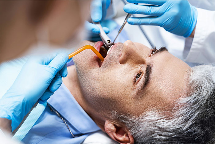 Patient awake during surgery with medical staff wearing blue gloves performing a procedure in a clinical setting