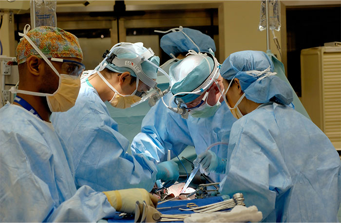 Surgical team performing an operation in a sterile room with focus on unexpected waking during surgery incidents.