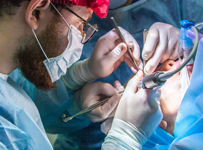 Surgeons performing delicate surgery with precision, highlighting bone-chilling and hilarious stories from surgery experiences.