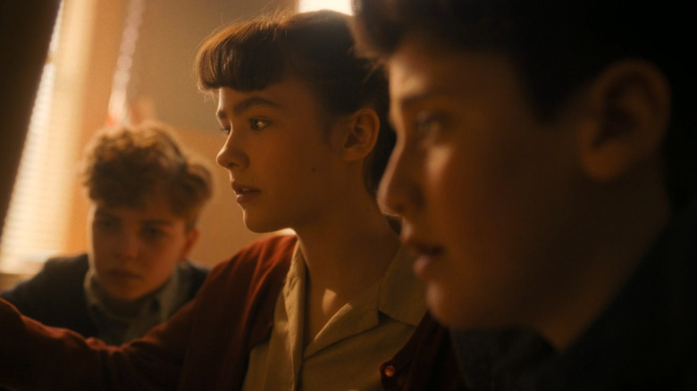 Teddy, Lilly and Phil doing research at the library in It: Welcome to Derry