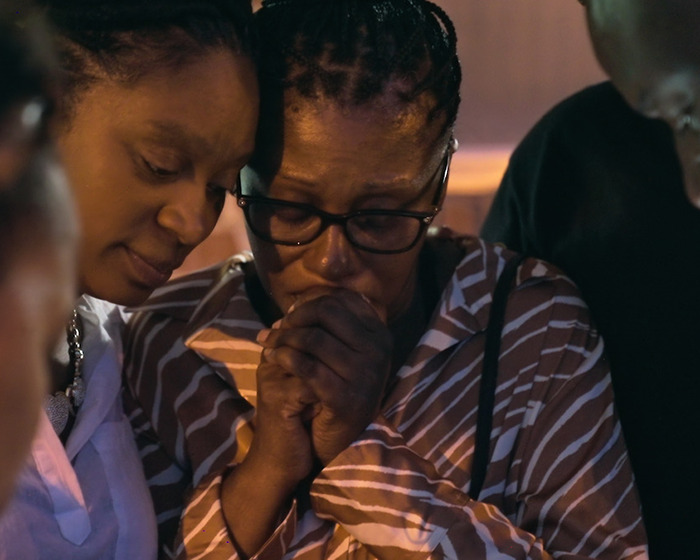 Two distressed women in a close embrace, reflecting the gut-wrenching emotions of Netflix’s The Perfect Neighbor true story.