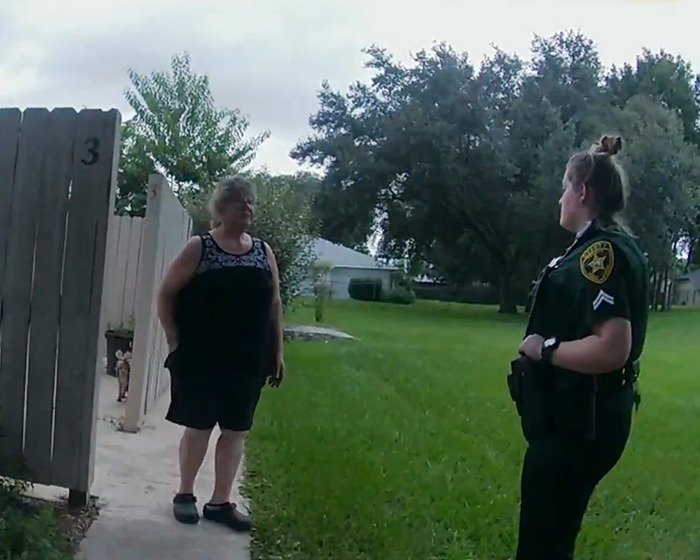 A police officer talking to a woman outside a house, related to Netflix’s The Perfect Neighbor disturbing true story.