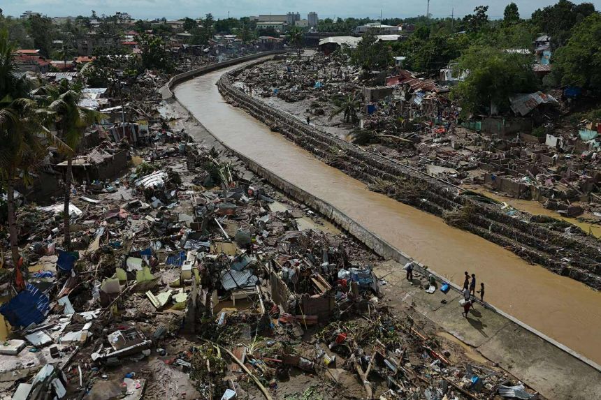 Residents return to what remains of their homes after Typhoon Kalmaegi devastated communities along the Mananga River in Talisay City in the Philippines on November 5.