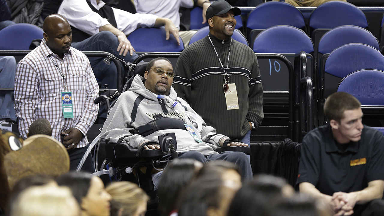 Rodney Rogers, center, watches a game between Wake Forest and Maryland in Greensboro on March 14, 2013.