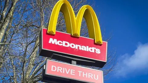 Getty Images A large red McDonald's sign with the yellow arches with a blue sky in the background