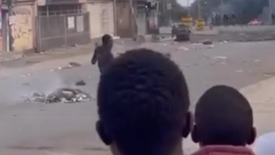 A protester is seen walking towards a police position at the top of the road in Arusha, on October 29, 2025. - Obtained by CNN