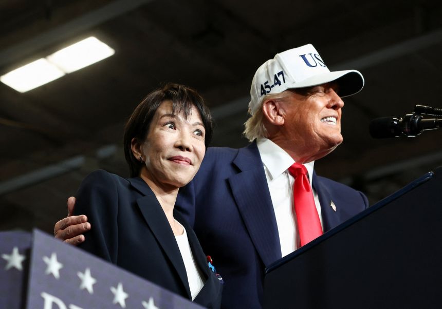 Japanese Prime Minister Sanae Takaichi reacts as US President Donald Trump speaks, aboard the aircraft carrier USS George Washington, during a visit to US Navy's Yokosuka base in Yokosuka, Japan, on October 28, 2025.
