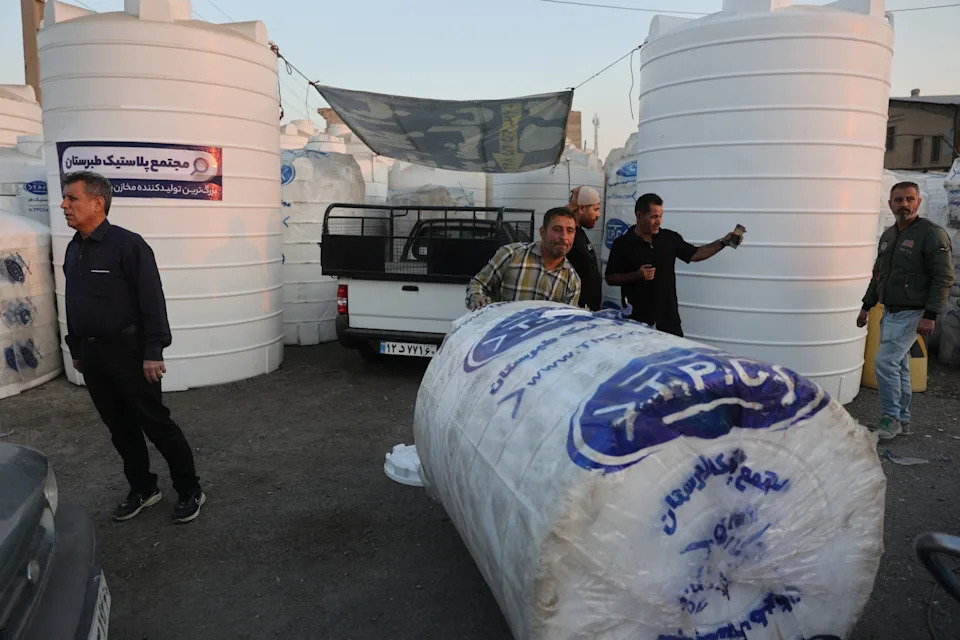 People purchase water storage tanks following drought conditions in Tehran