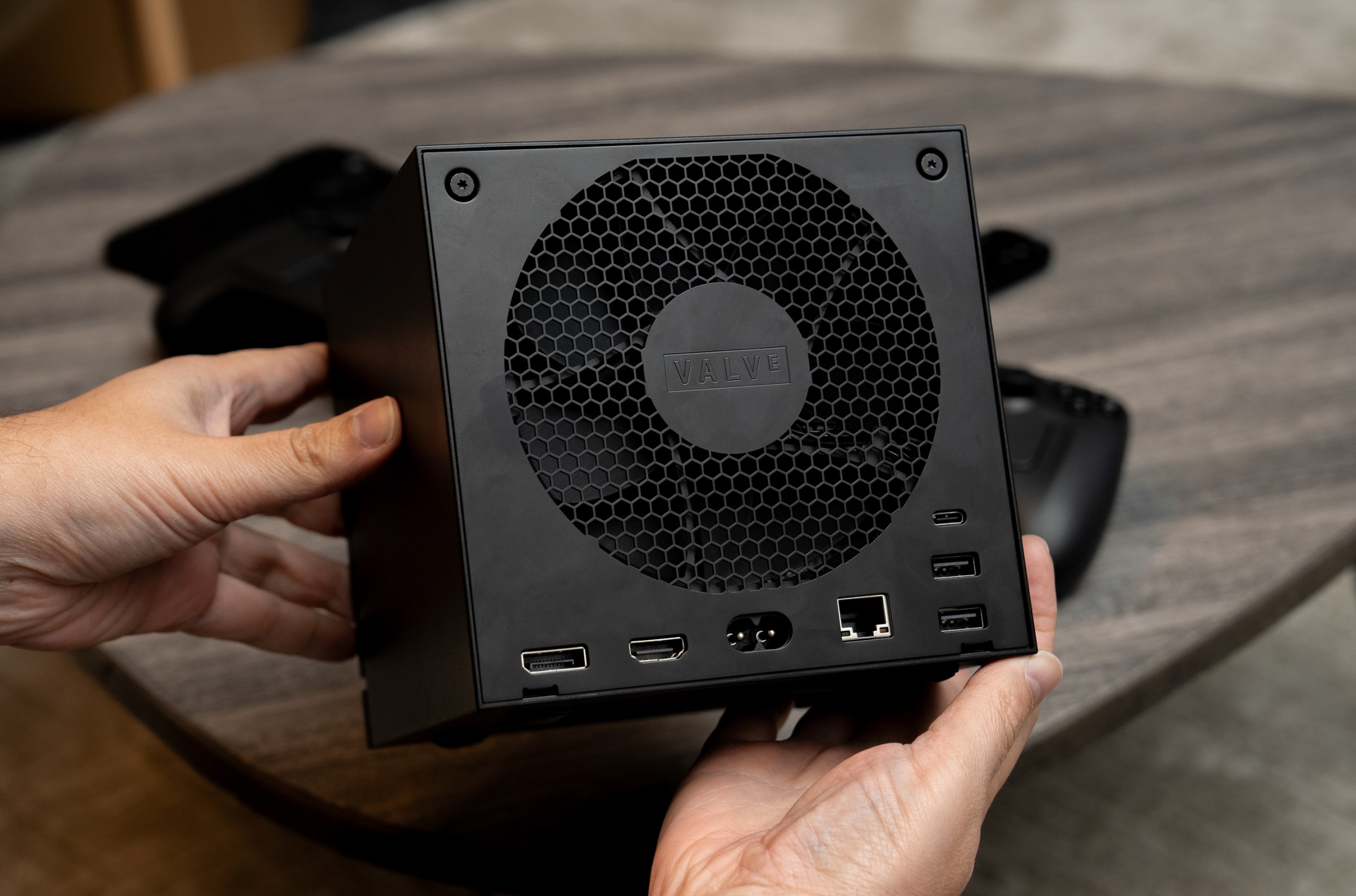 The Steam Machine’s rear, showing how a 120mm fan takes up almost the entirety, but surrounded by ports including USB-A, C, Ethernet, HDMI, and DisplayPort.