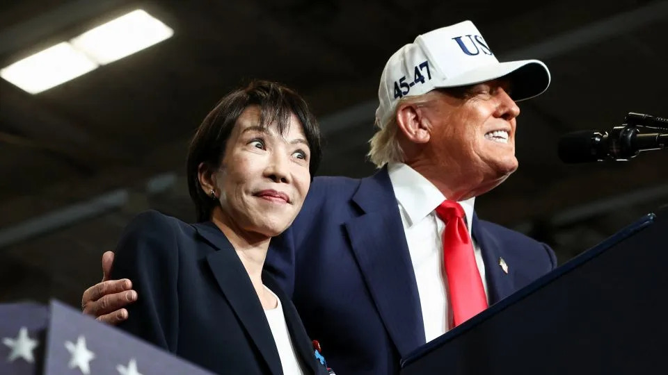 Japanese Prime Minister Sanae Takaichi reacts as US President Donald Trump speaks, aboard the aircraft carrier USS George Washington, during a visit to US Navy's Yokosuka base in Yokosuka, Japan, on October 28, 2025. - Evelyn Hockstein/Reuters