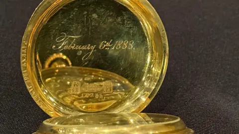 BNPS A golden watch engraved on the inside with February 6th 1888.
