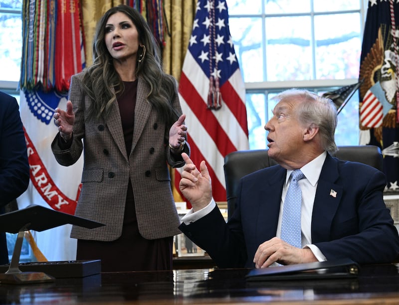 US President Donald Trump (C) and FIFA president Gianni Infantino (R) listens to the US Secretary of Homeland Security Kristi Noem during a meeting