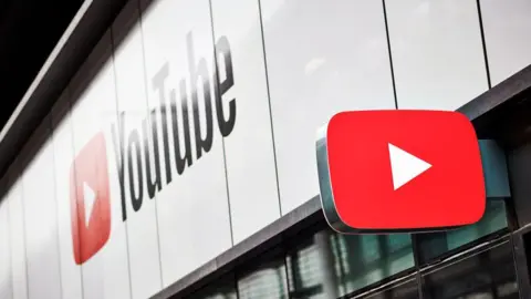 Getty Images The YouTube brand on the side of a building, with a sign in the shape of the YouTube logo jutting out from the same building