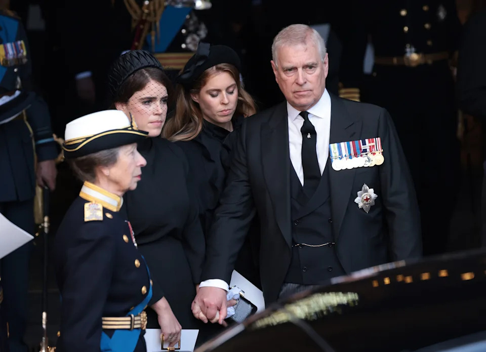 Prince Andrew holding hands with Princess Eugenie and Princess Beatrice at Queen Elizabeth's funeral