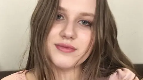 Julia Wandelt Julia Wandelt, with long dark hair, looks straight at the camera
