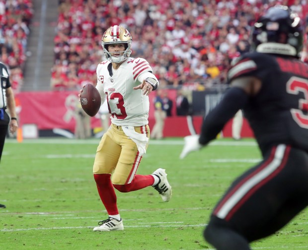 49ers quarterback Brock Purdy #13 looks for an open receiver during the game between the San Francisco 49ers and the Arizona Cardinals at State Farm Stadium on Nov. 16, 2025 in Glendale, Arizona. The 49ers defeated the Cardinals 41-22. ..(John Medina/Special to Bay Area News Group)