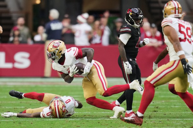 San Francisco 49ers safety Malik Mustapha (6) returns an interception against the Arizona Cardinals during the first half of an NFL football game in Glendale, Ariz., Sunday, Nov. 16, 2025. (AP Photo/Rick Scuteri)