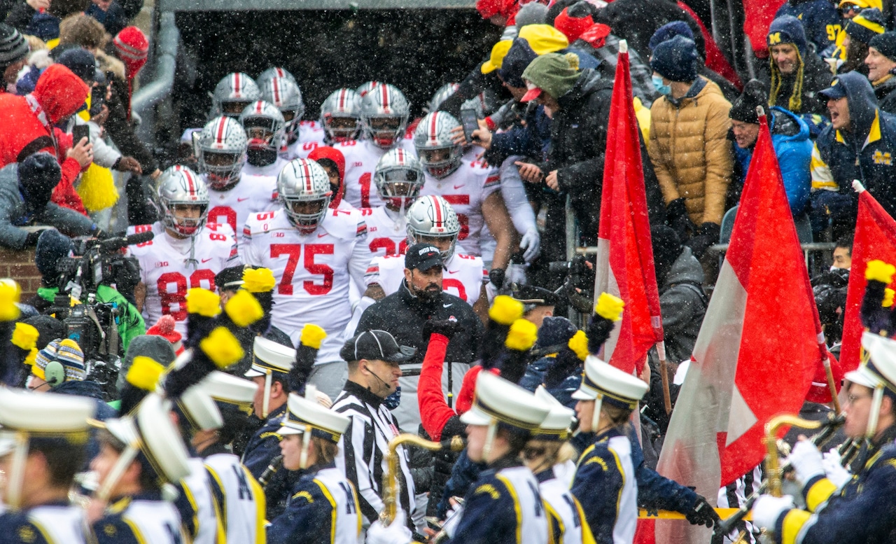Ohio State head coach Ryan Day, center, leads his team out of the Michigan Stadium tunnel to take the filed before an NCAA college football game against Michigan in Ann Arbor, Mich., Saturday, Nov. 27, 2021. Michigan won 42-27.