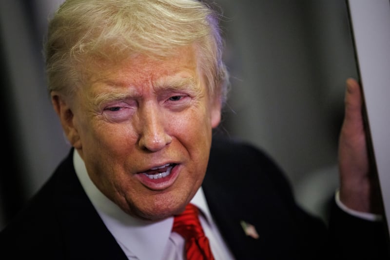 President Donald Trump speaks to reporters aboard Air Force One en route to the White House on November 2, 2025.