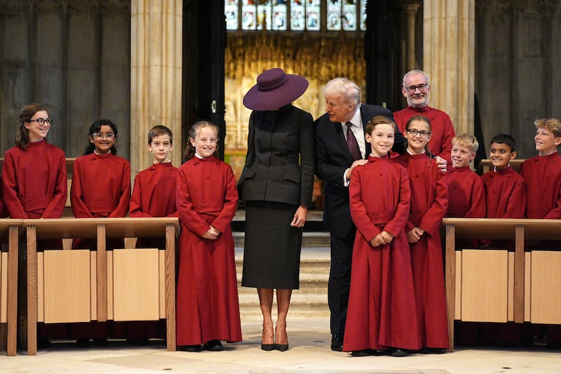 WINDSOR, ENGLAND - SEPTEMBER 17: US President Donald Trump and First Lady Melania Trump meet young members of the choir during a visit to St George's Chapel at Windsor Castle during the State visit by the President of the United States of America on September 17, 2025 in Windsor, England. (Photo by Aaron Chown - WPA Pool/Getty Images)