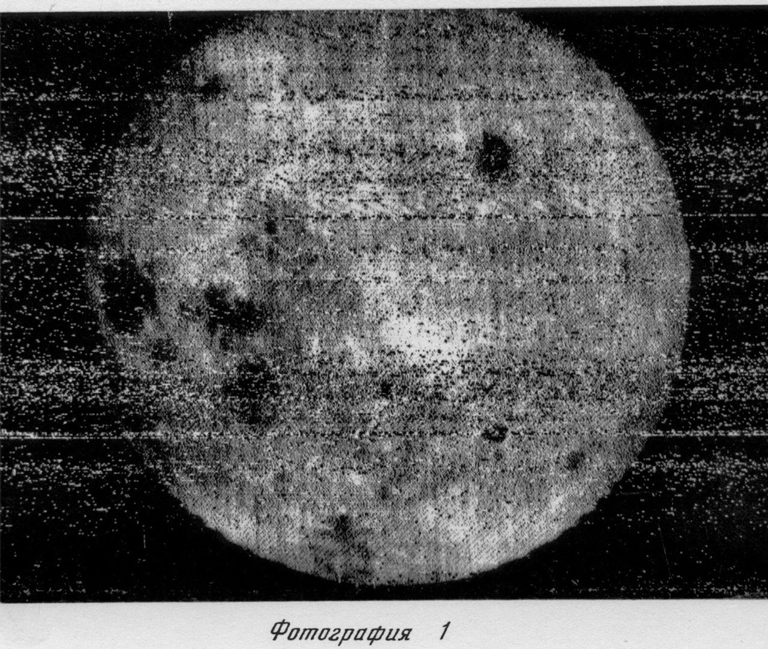Black and white, grainy image of the Moon’s surface with visible craters, possibly from the dark side moon, and text in Russian below the photo.